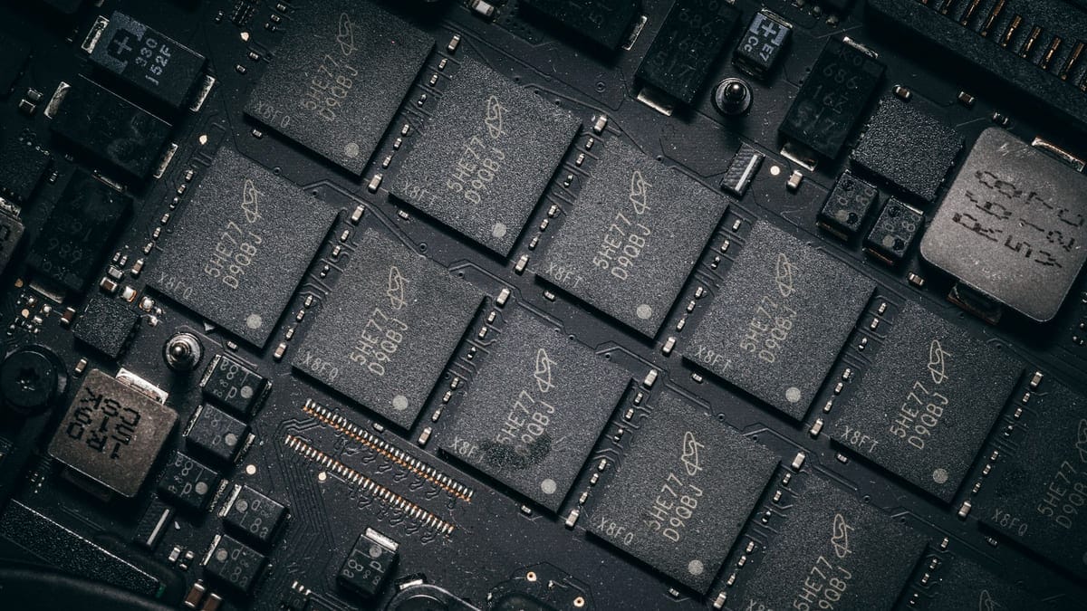 Detailed view of electronic circuit board components showcasing microchips and technology intricacies.