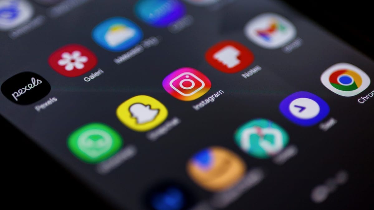 Close-up view of smartphone home screen featuring popular apps like Instagram, Snapchat, and Chrome.