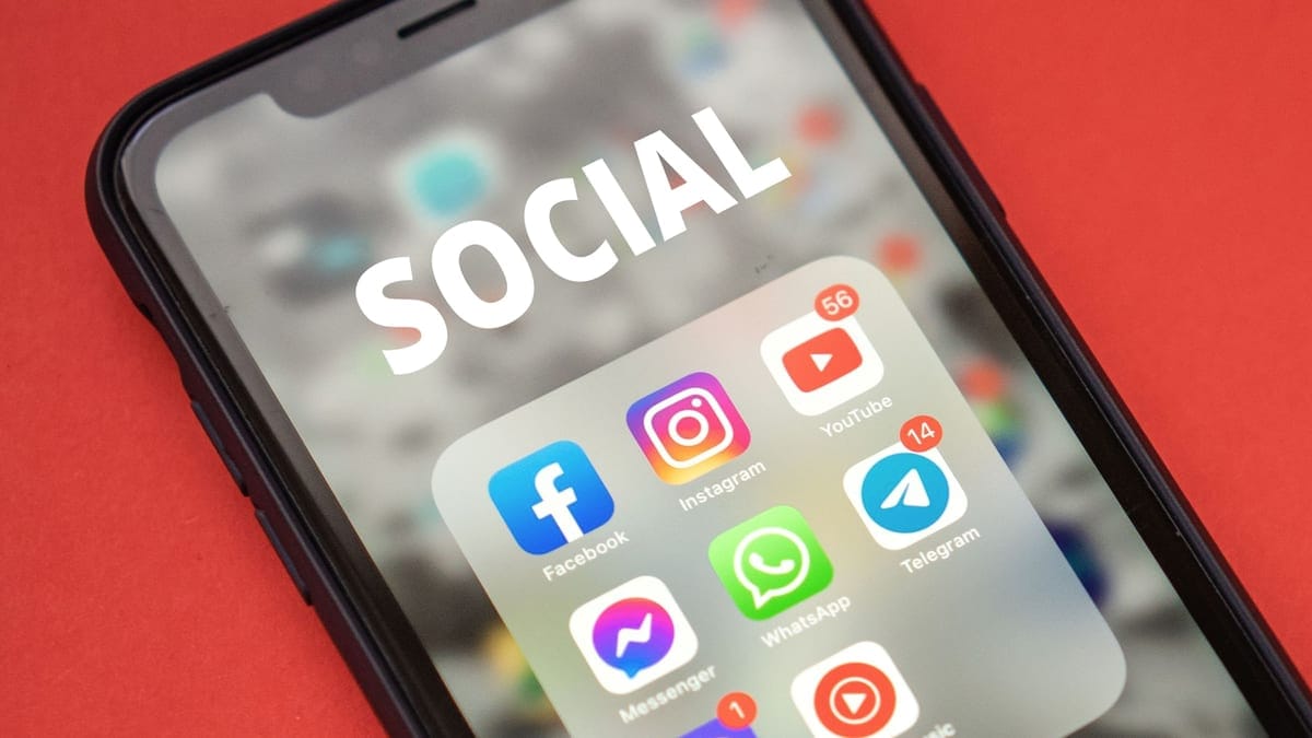 Close-up of a smartphone showing popular social media apps on screen.